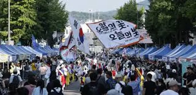 People in the streets of South Korea protesting with signs